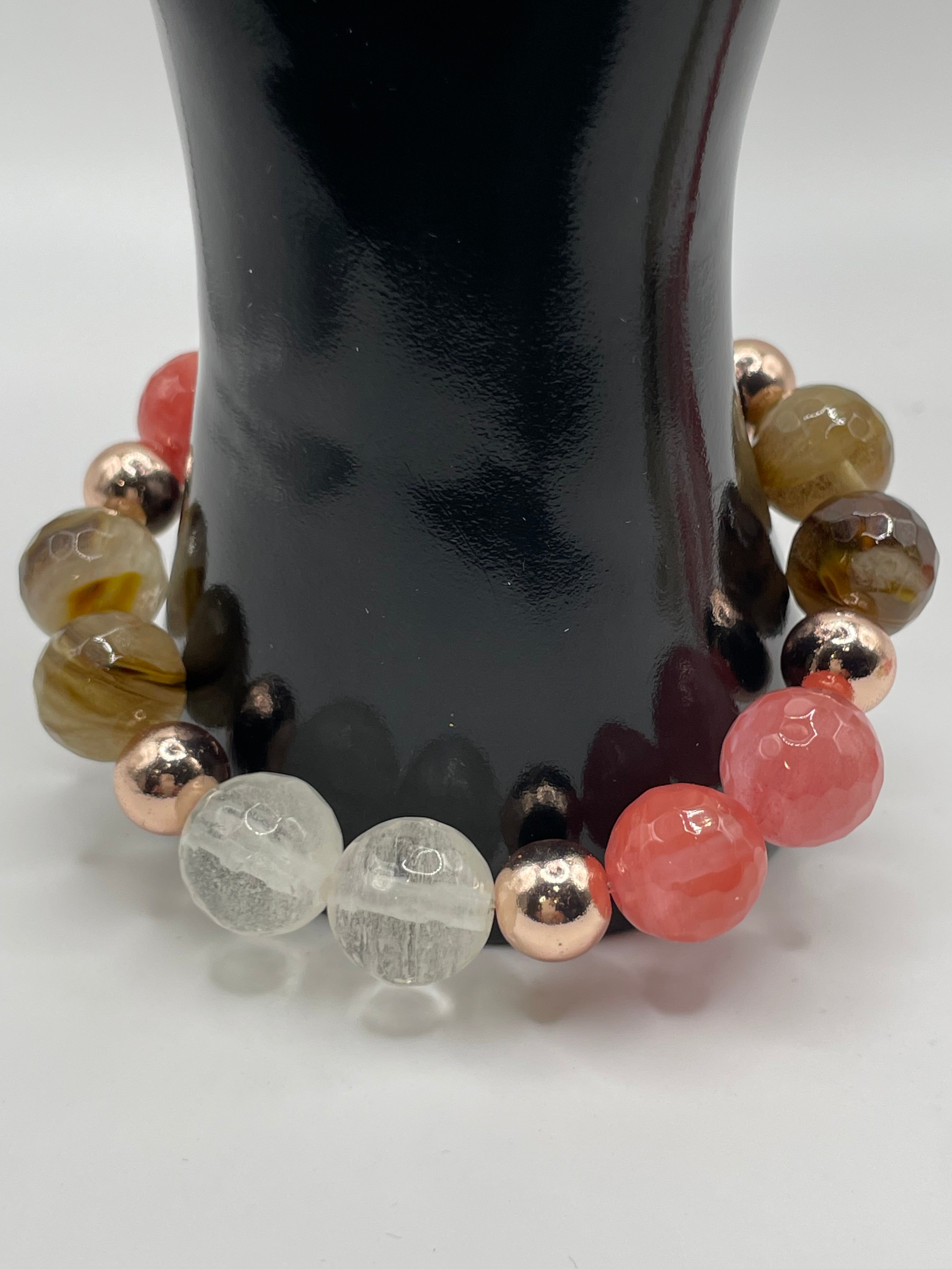 Multicolored beaded bracelet on a reflective surface
