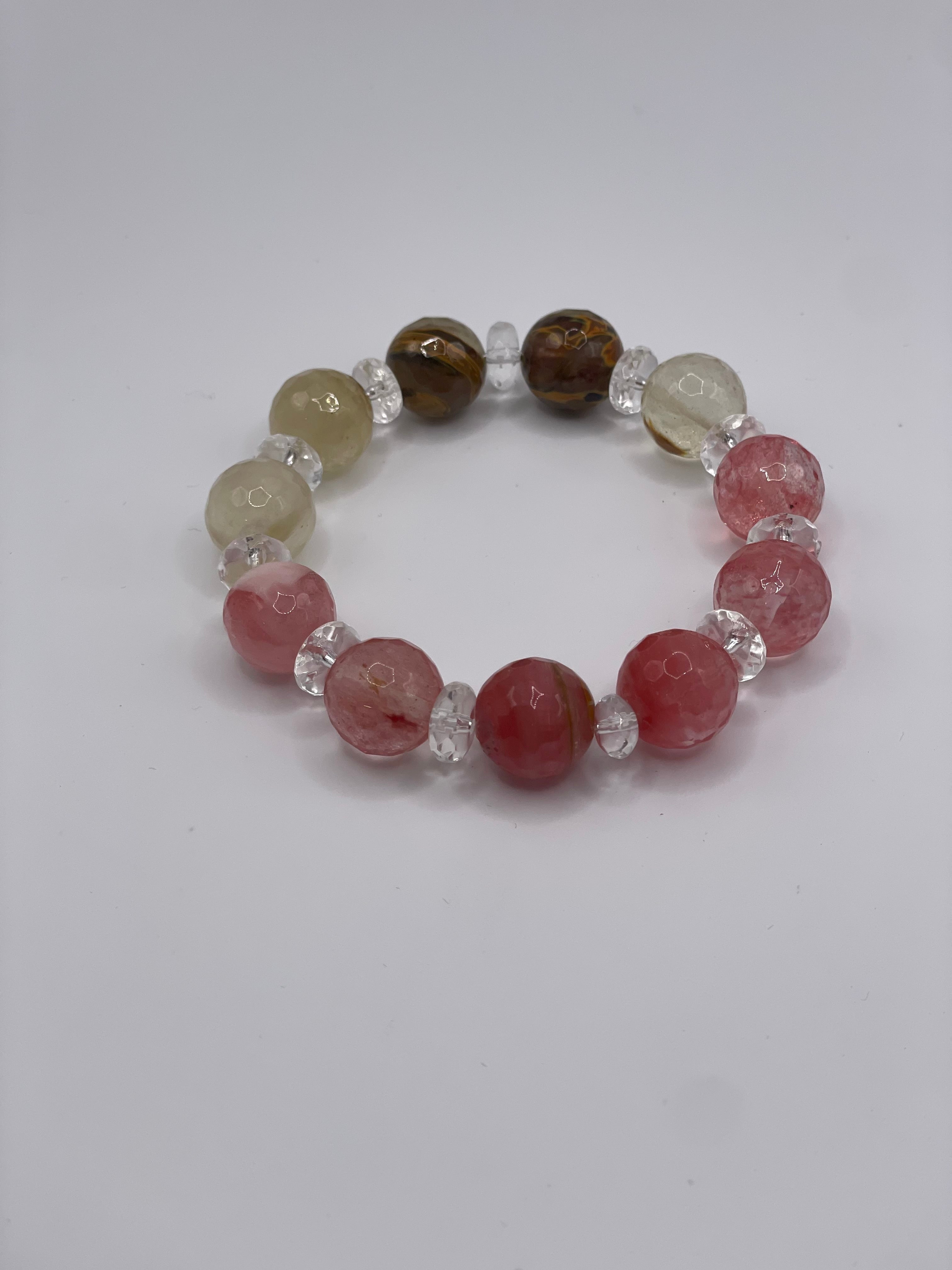 Beaded bracelet with pink, brown, and clear beads on a white background