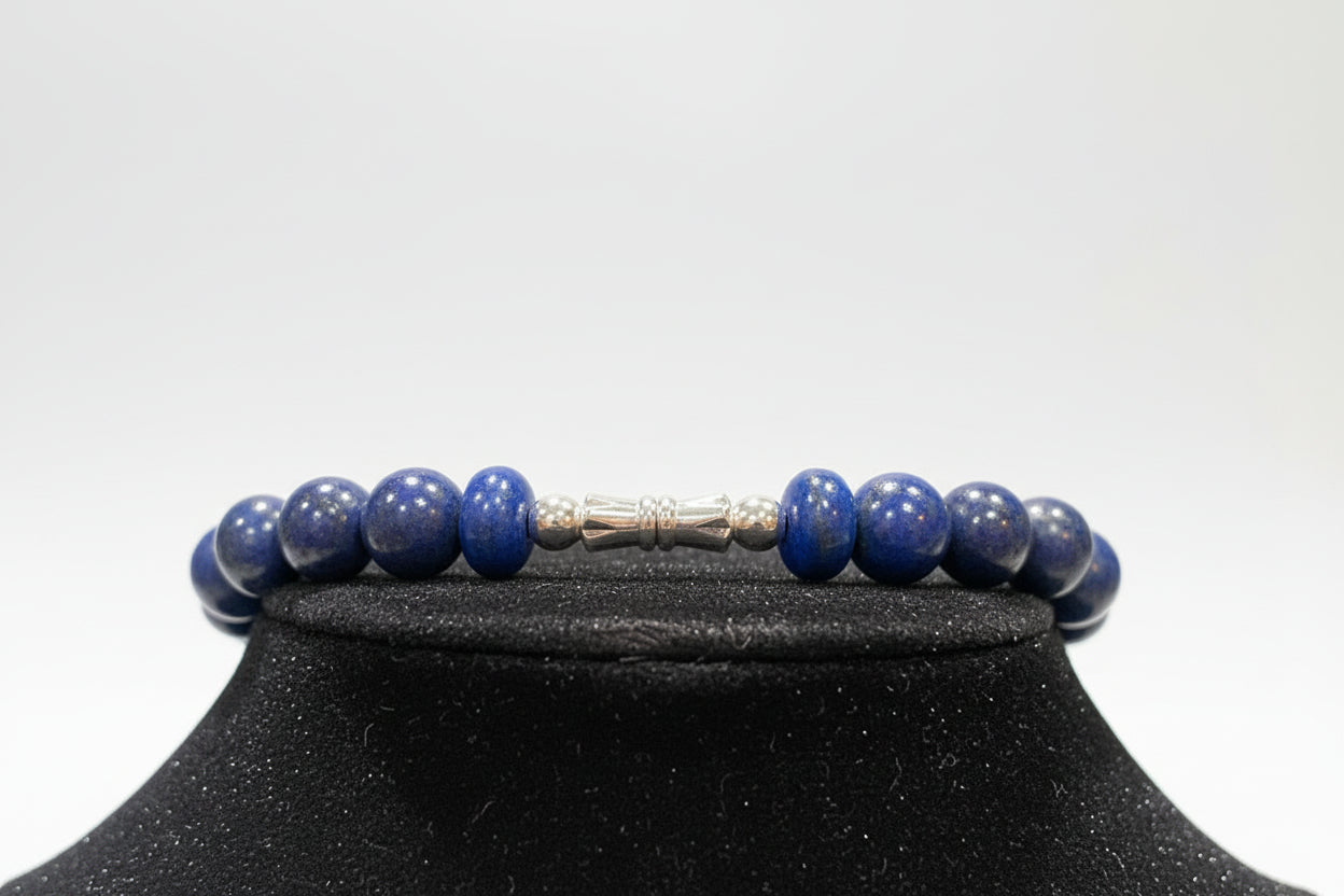 Lapis lazuli beaded necklace on a black stand with a blurred background