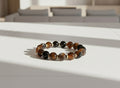 Beaded bracelet with brown and black stones with silver spacer