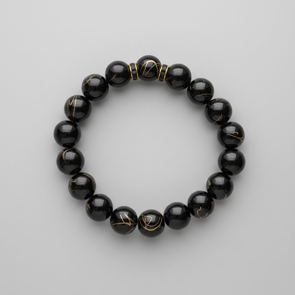 Black stripe & two black rhinestone spacer beaded bracelet on a wooden surface