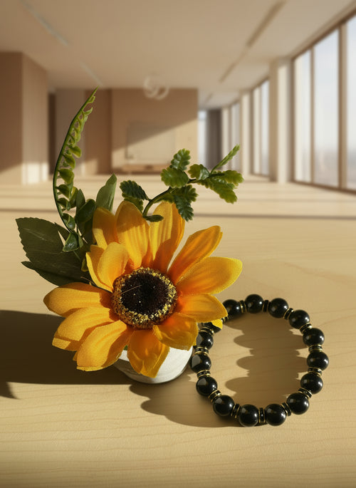 Black stone bracelet with golden black spacer