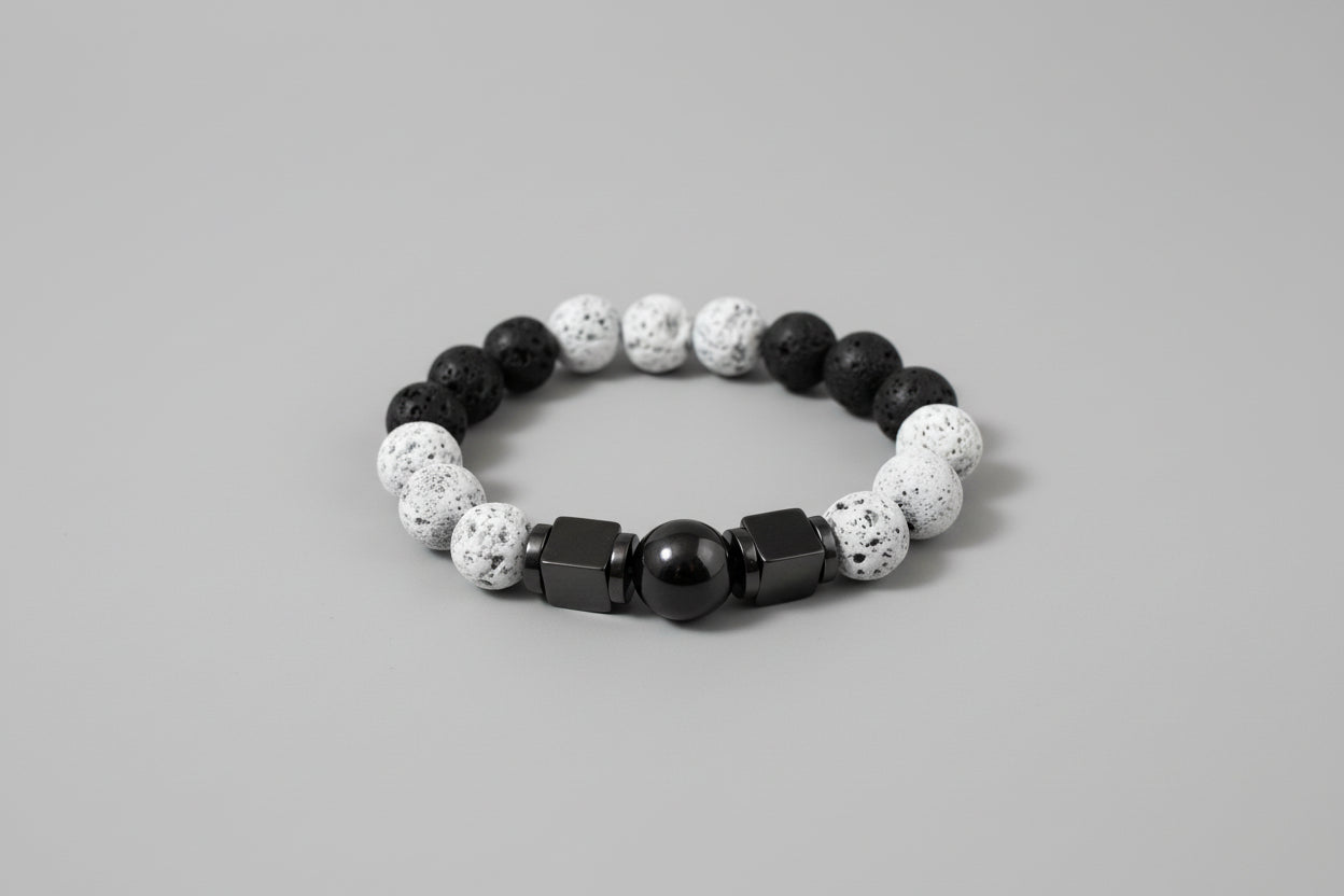 Bracelet with black, white, and gray beads on a wooden surface