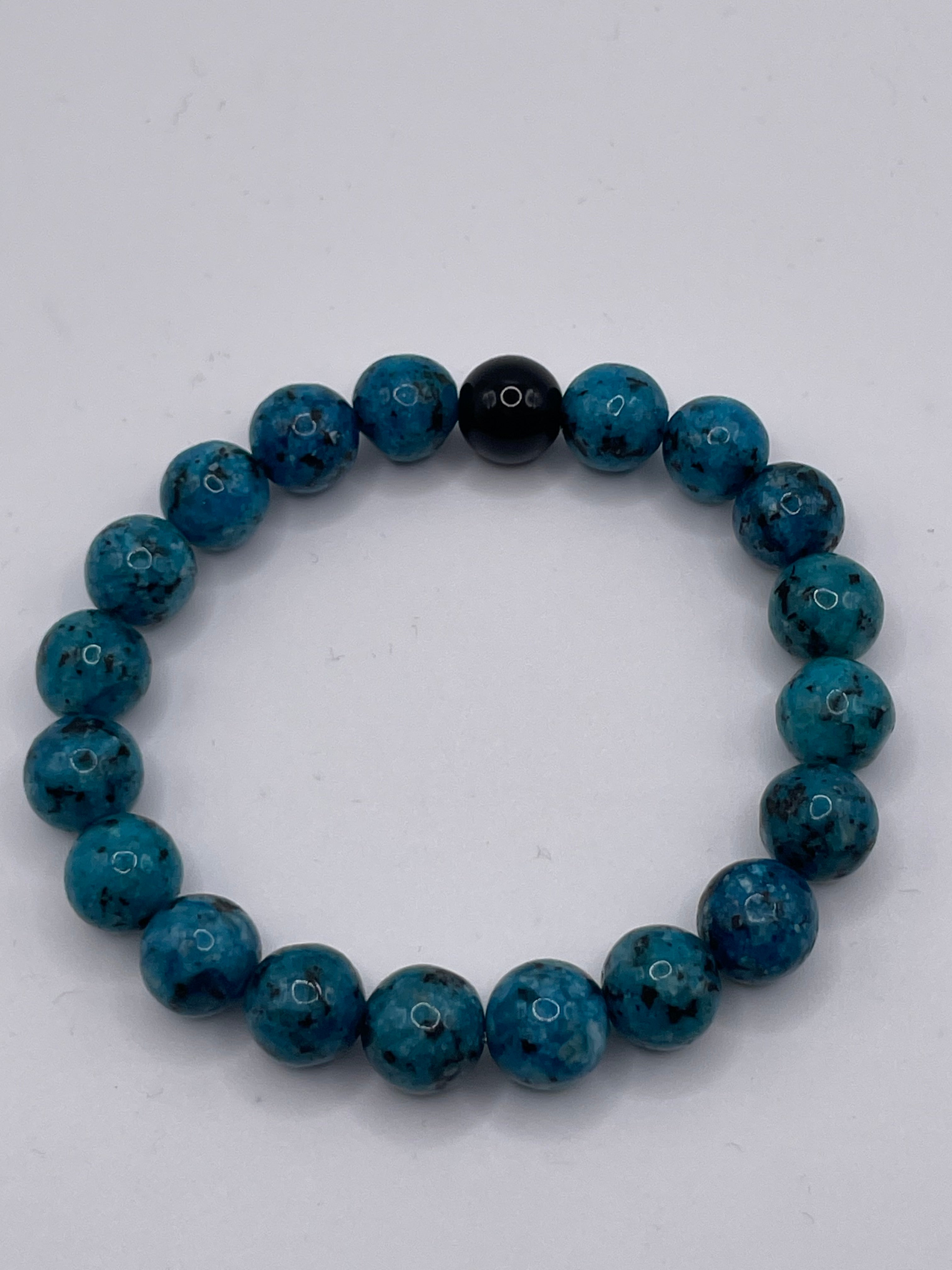 Blue beaded bracelet on a white background