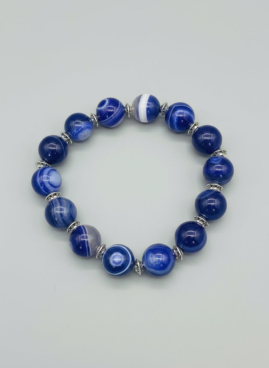 Blue beaded bracelet on a textured gray background