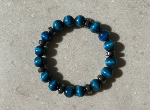 Blue beaded bracelet on a gray stone background