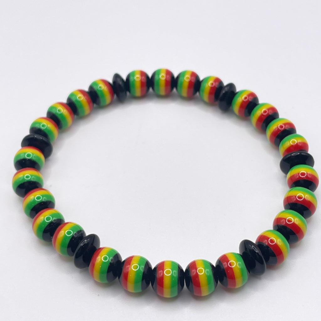 Colorful beaded bracelet with black, red, yellow, and green pattern on a white background
