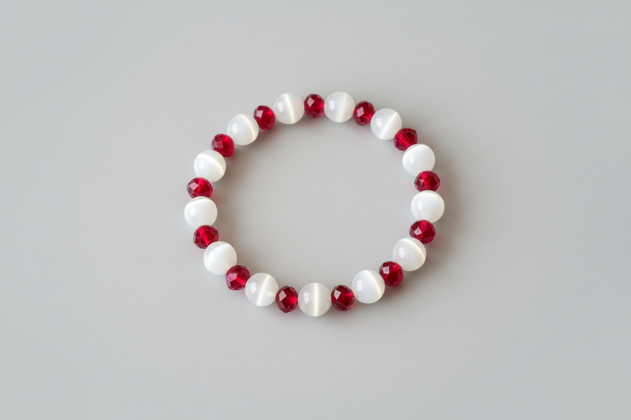 Bracelet with red and white beads on a wooden surface