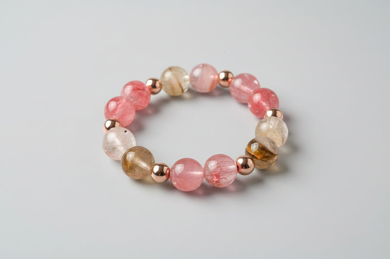 Beaded bracelet with pink, gold, and brown beads on a light gray background