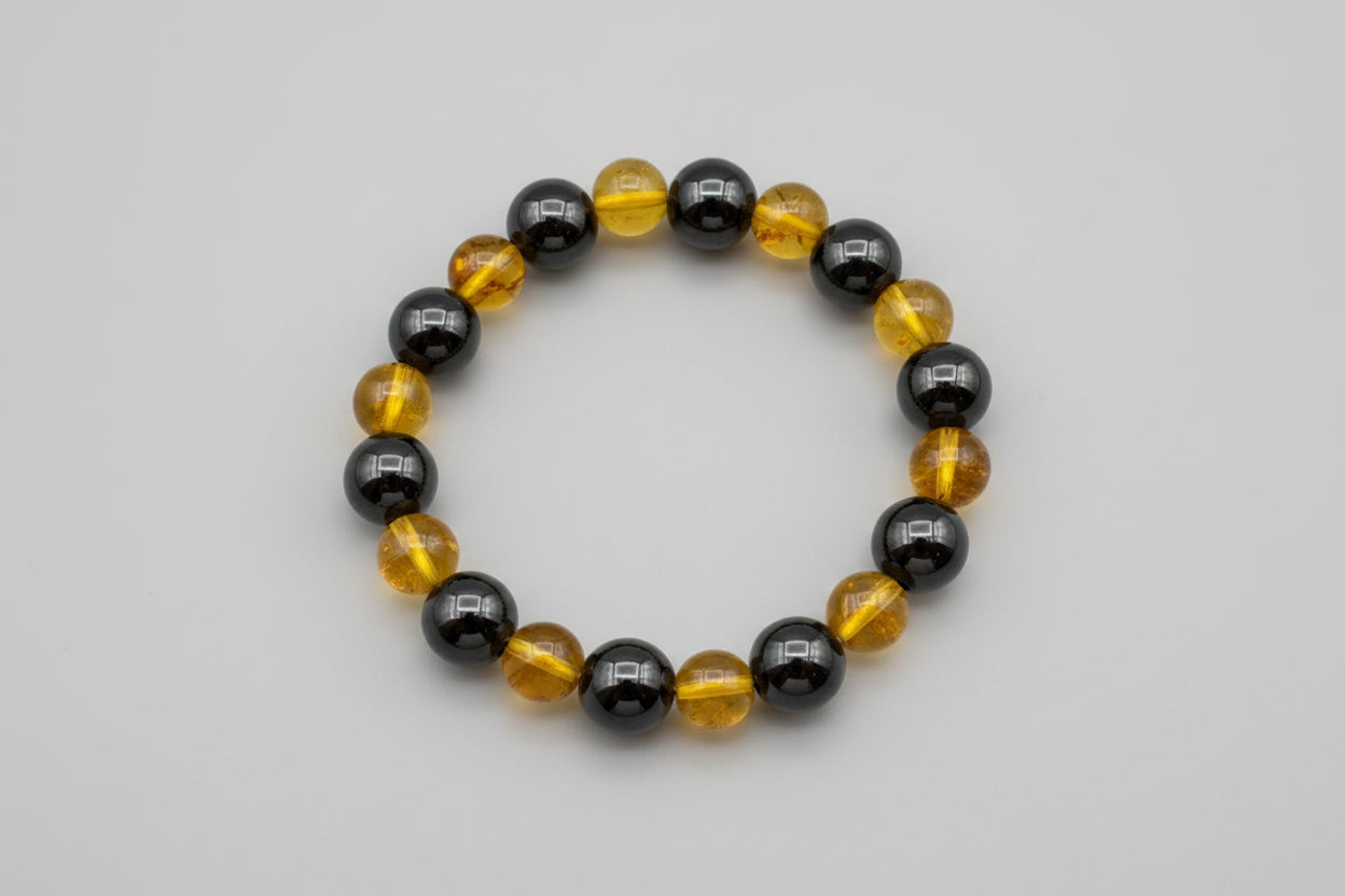 Bracelet with black and yellow beads on a wooden surface