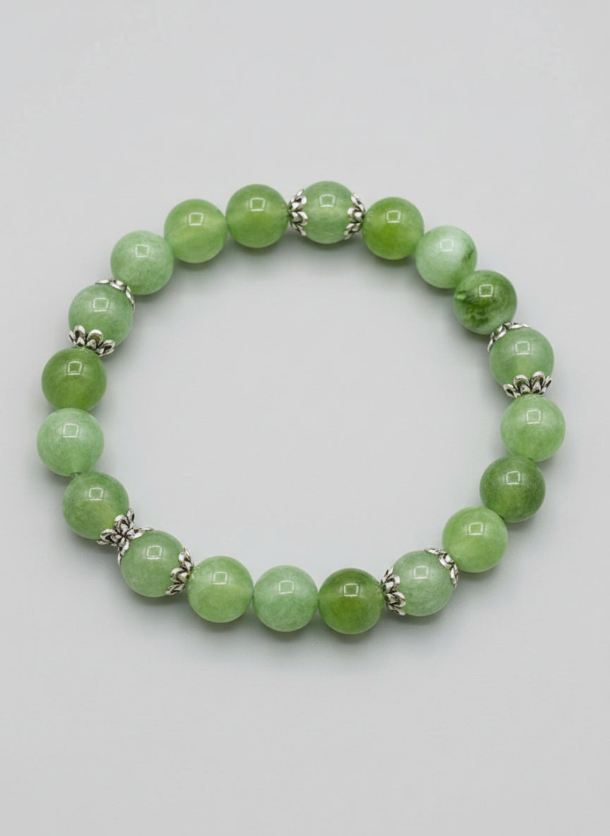 Green beaded bracelet on a light gray background