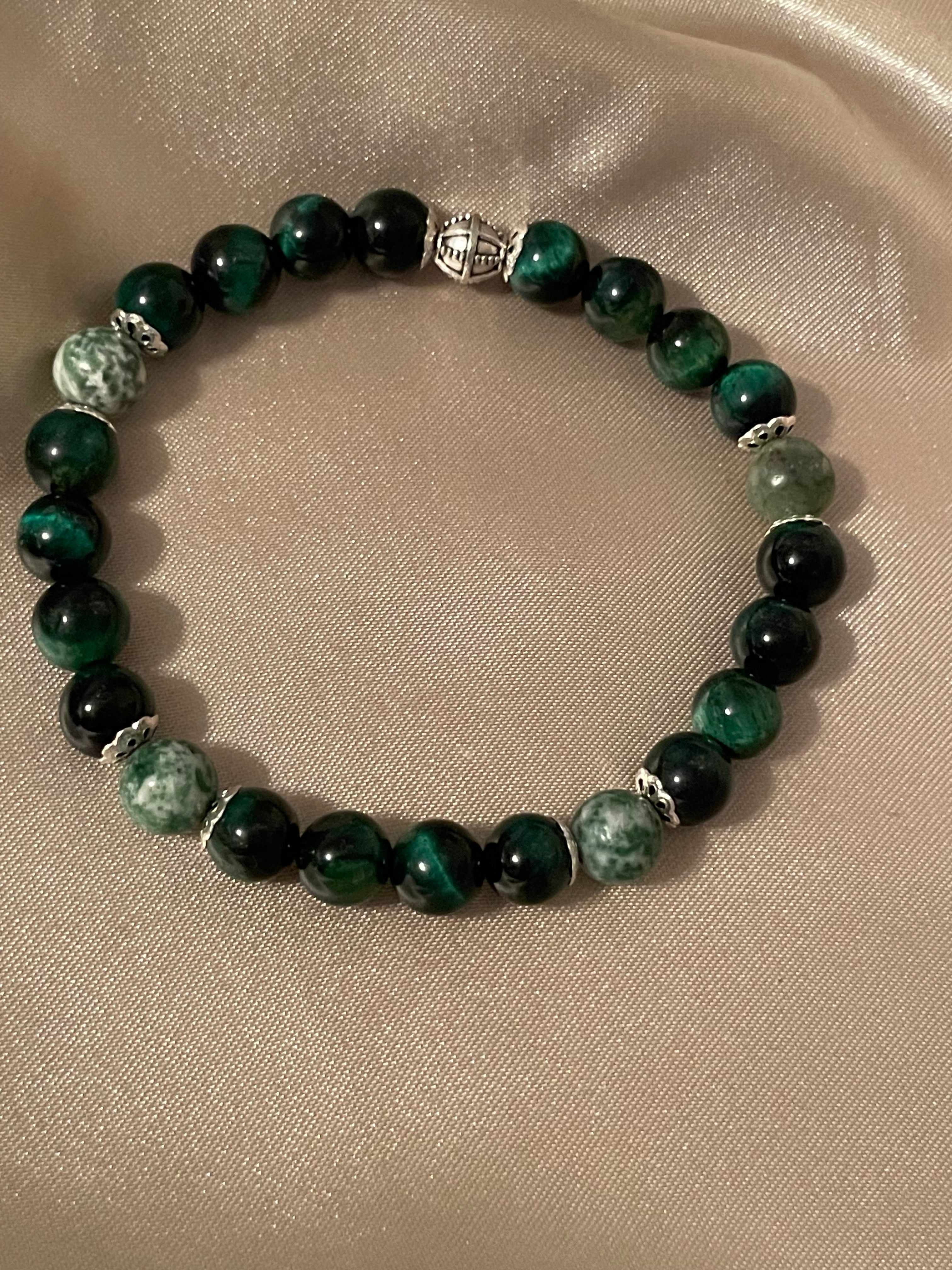 Green tiger & jasper beaded 8 mm bracelet on a beige fabric background