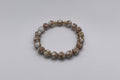 Beaded bracelet with gold accents on a white background