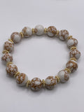 Bracelet with brown and white marbled beads on a light gray background