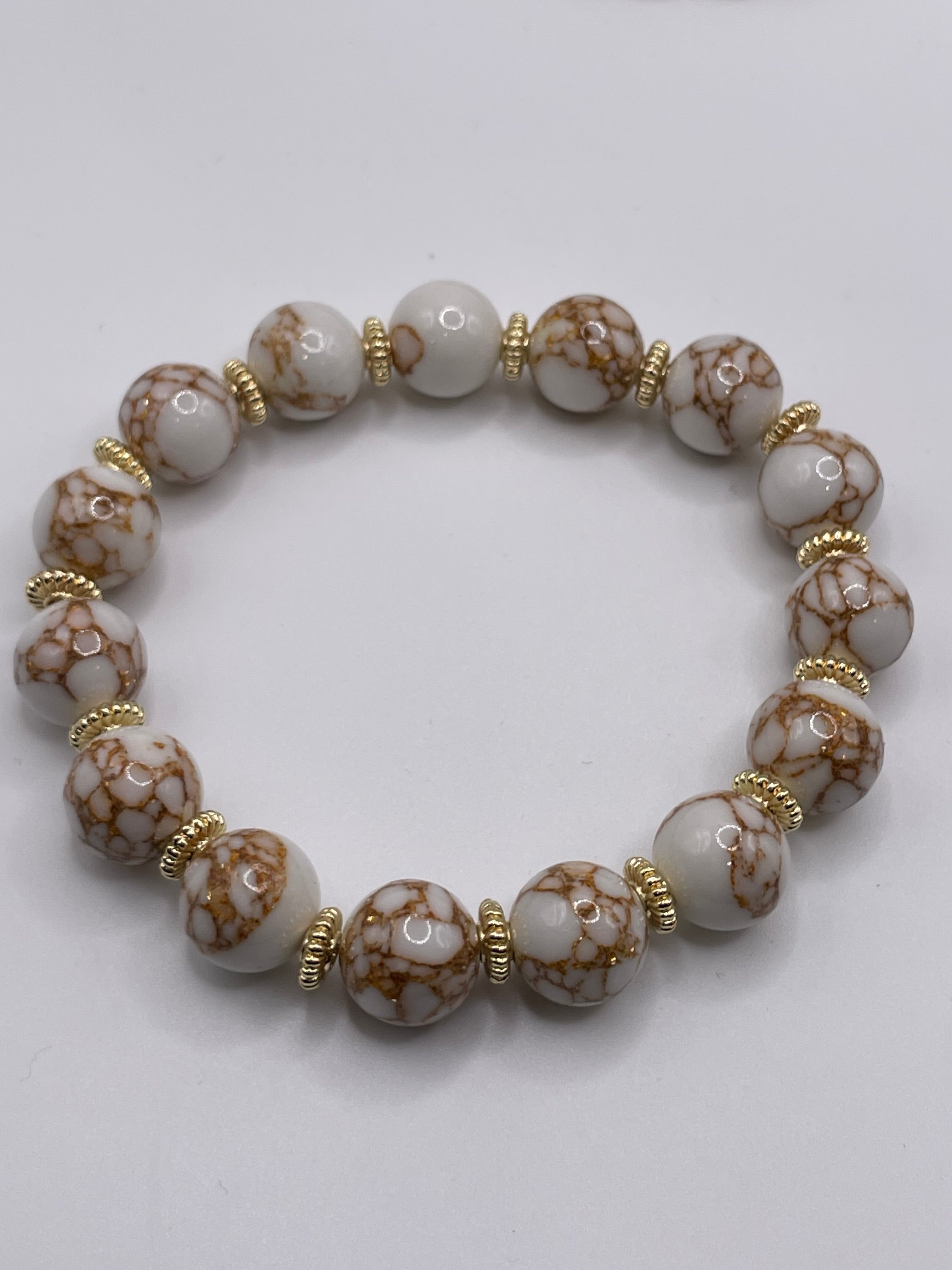 Bracelet with brown and white marbled beads on a light gray background