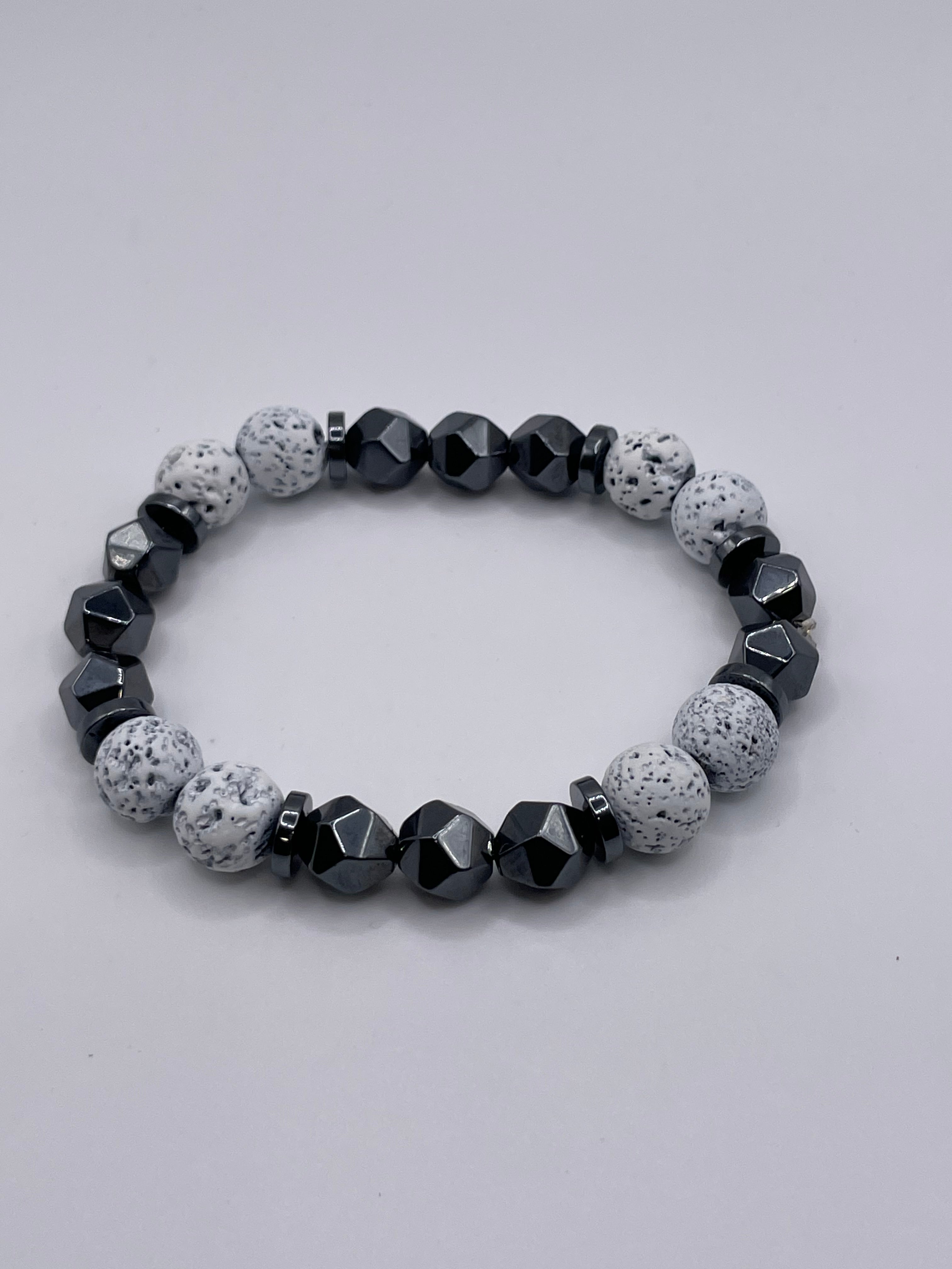 Bracelet with gray and black beads on a light gray background