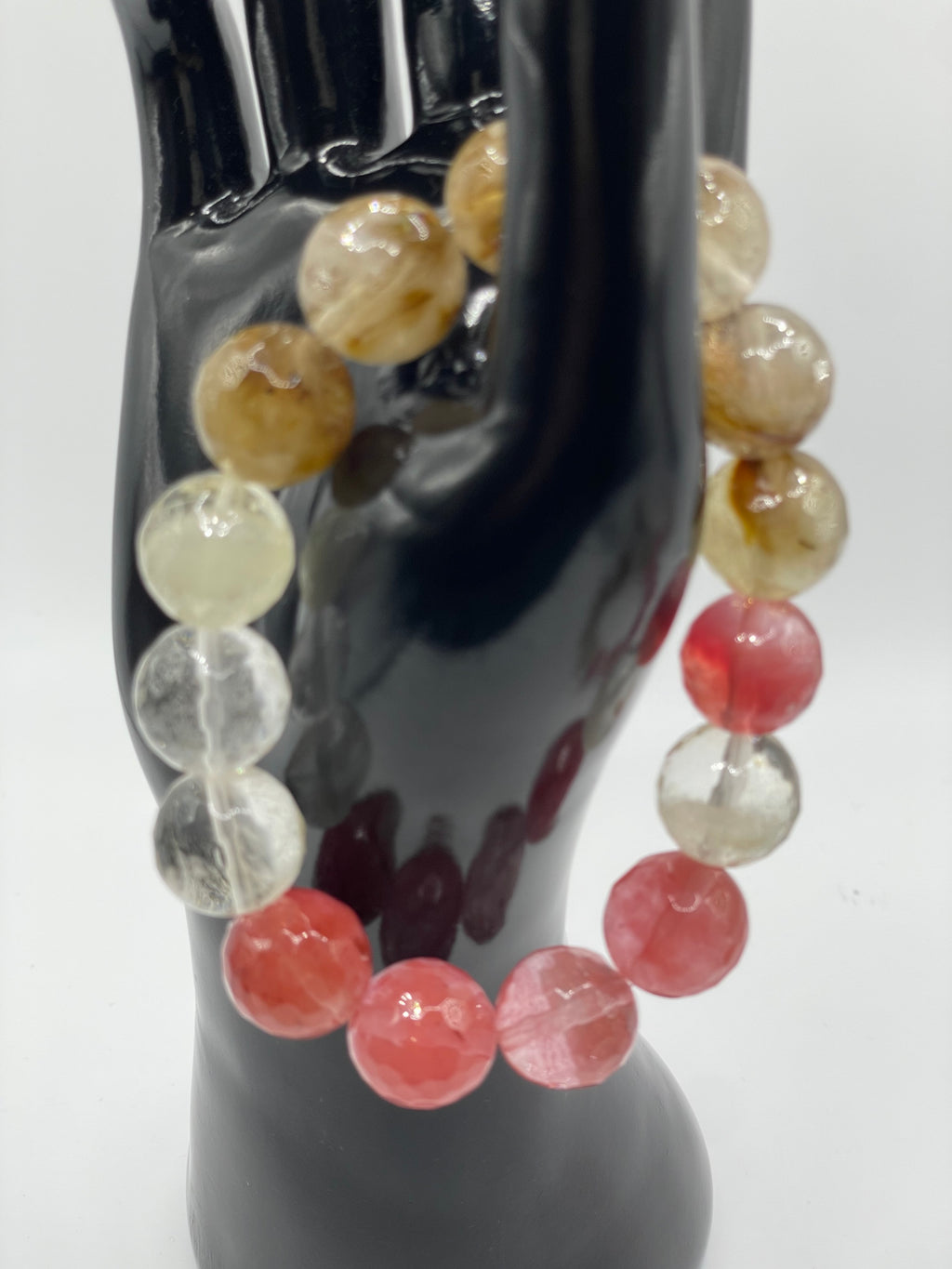 Multicolored beaded bracelet on a reflective surface