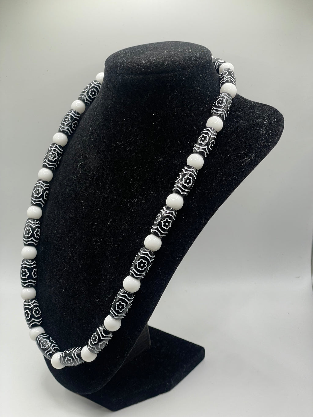 Natural Smooth White Stone and Floral Acrylic Bead Necklace on black bust display