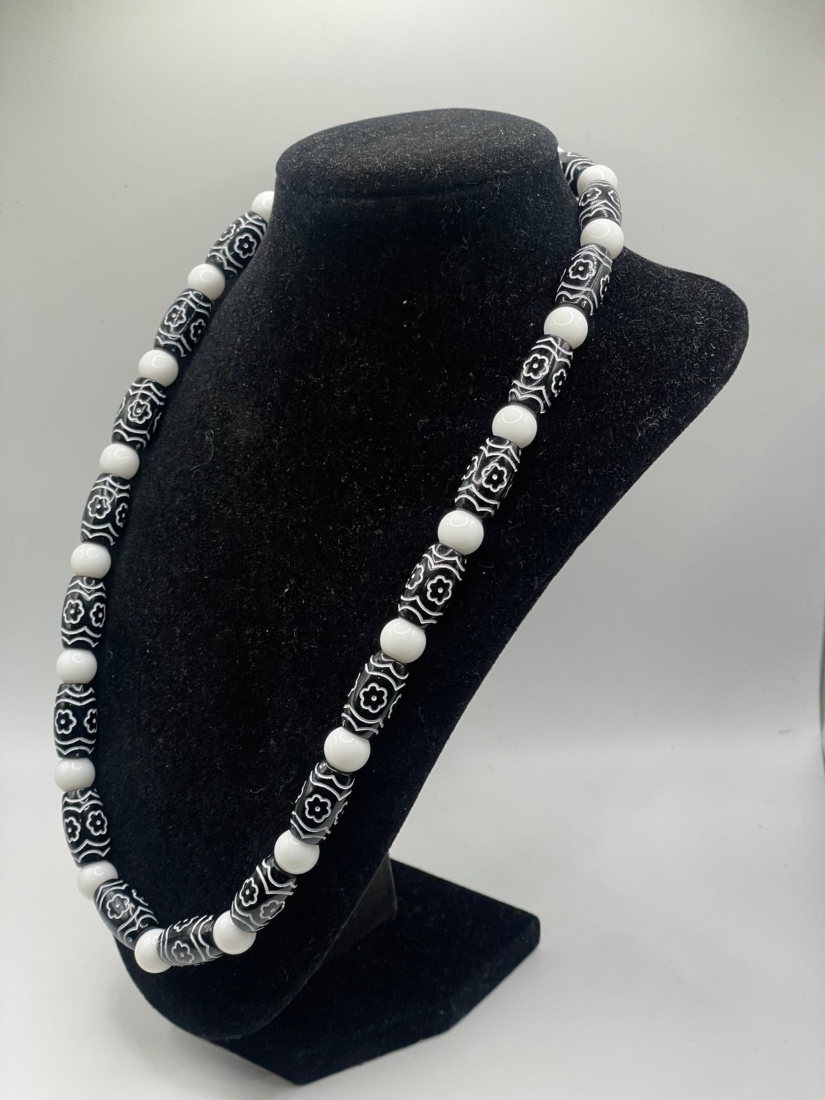 Natural Smooth White Stone and Floral Acrylic Bead Necklace on black bust display