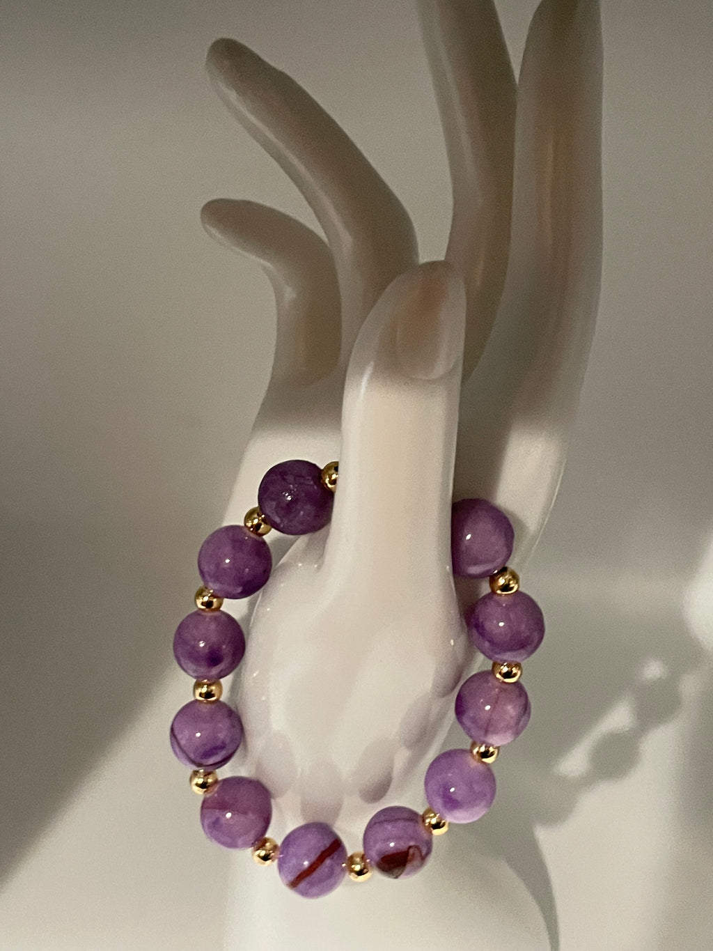 Purple Persian Gulf Chalcedony and gold spacer bracelet displayed on hand mannequin