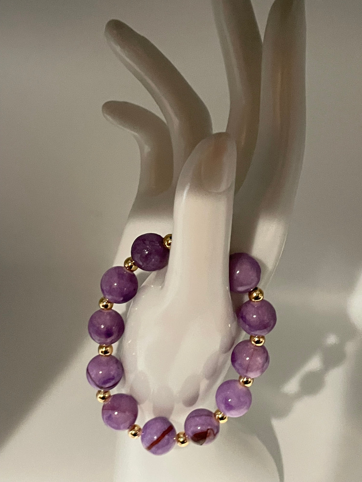Purple Persian Gulf Chalcedony and gold spacer bracelet displayed on hand mannequin