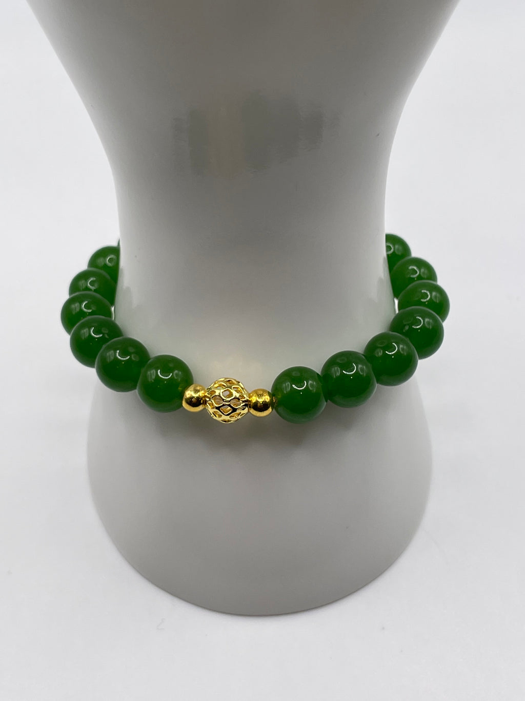 Raw jade 10mm bracelet with 18kt gold focal bead on wrist display