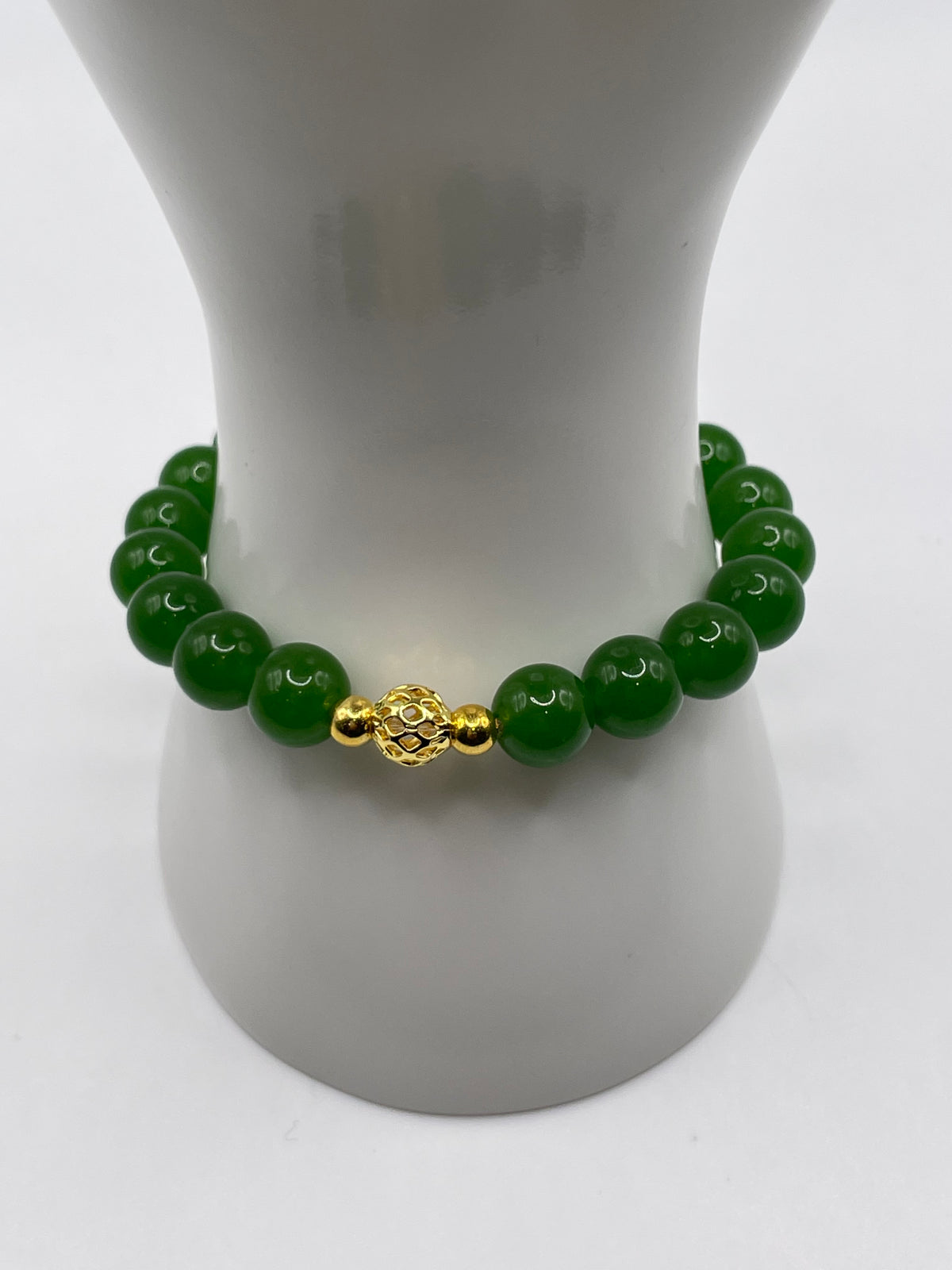 Raw jade 10mm bracelet with 18kt gold focal bead on wrist display