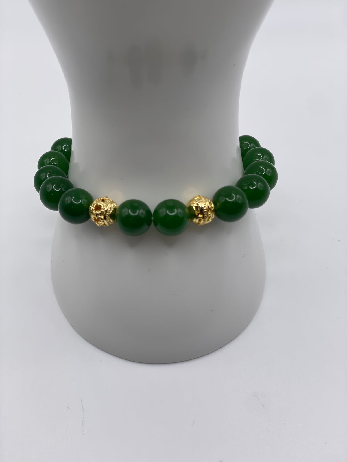 Raw jade 10mm bracelet with 18kt gold plated spacers on wrist display