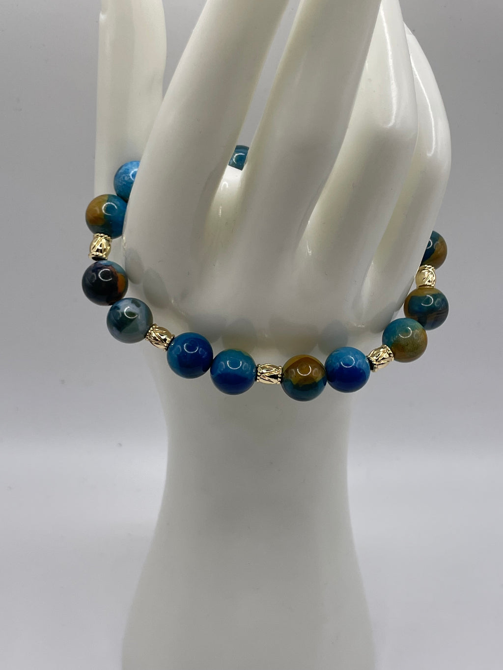 Blue and Yellow Agate Bead Bracelet 10mm with 8 gold spacers on hand display 2