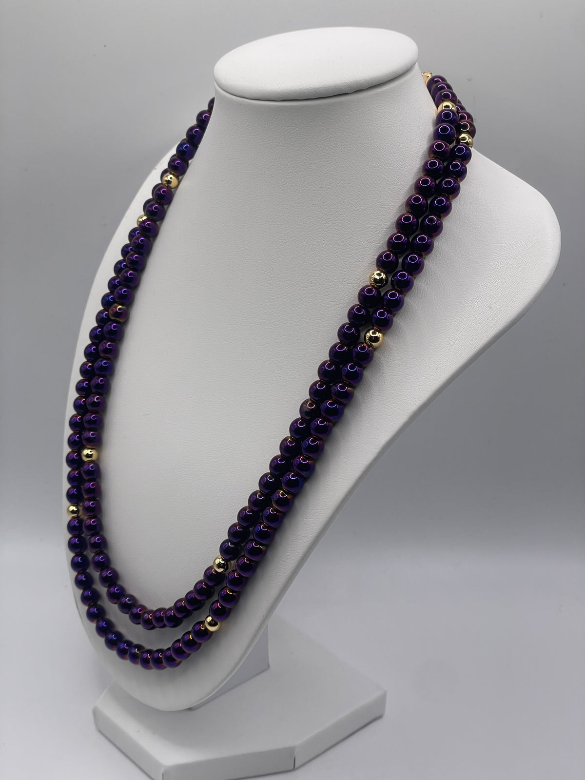Purple Hematite 6mm double chain necklace with gold beads on necklace bust display, side view