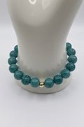 Aquamarine blue sponge agate bracelet with small gold spacers on wrist display