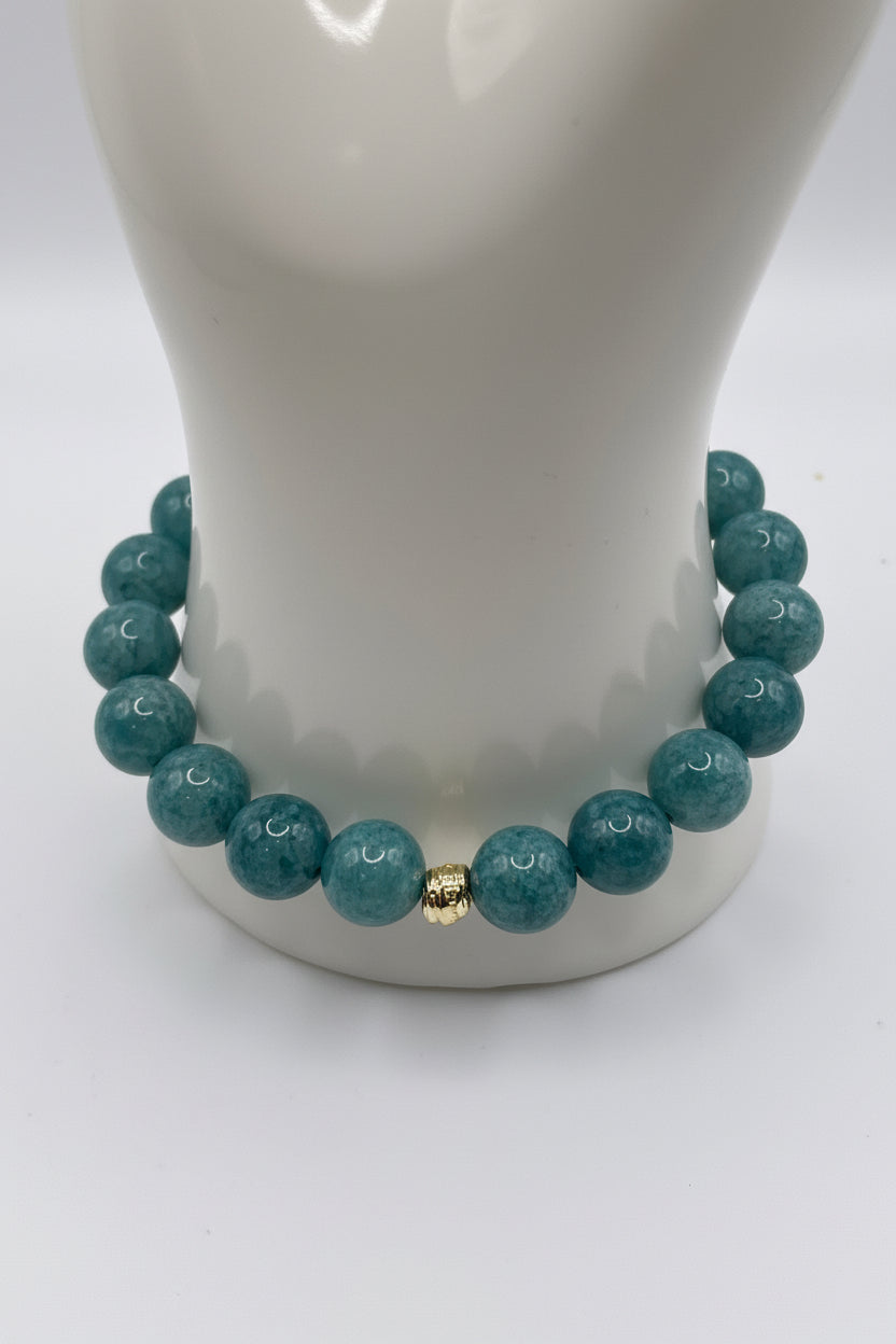 Aquamarine blue sponge agate bracelet with small gold spacers on wrist display