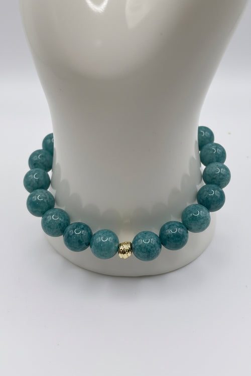 Aquamarine blue sponge agate bracelet with small gold spacers on wrist display