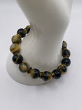 12mm Dream Tiger Eye bracelet with black and gold rhinestone spacers on mannequin wrist display