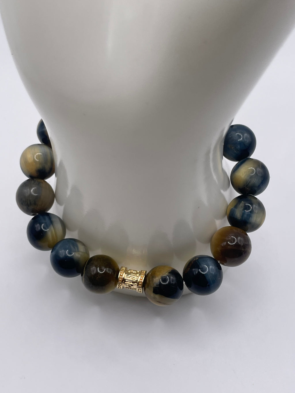 12mm Dream Tiger Eye stone bracelet with 18kt gold plated barrel charm on mannequin wrist display