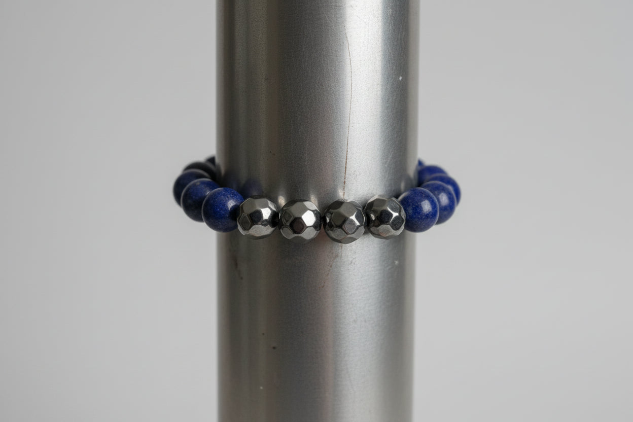 Bracelet with blue and silver beads on a metallic surface