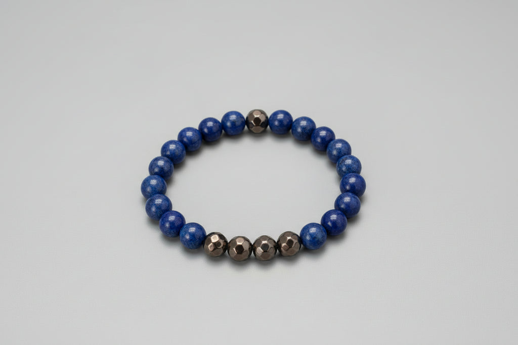 Blue beaded bracelet with brown faceted beads on a black surface