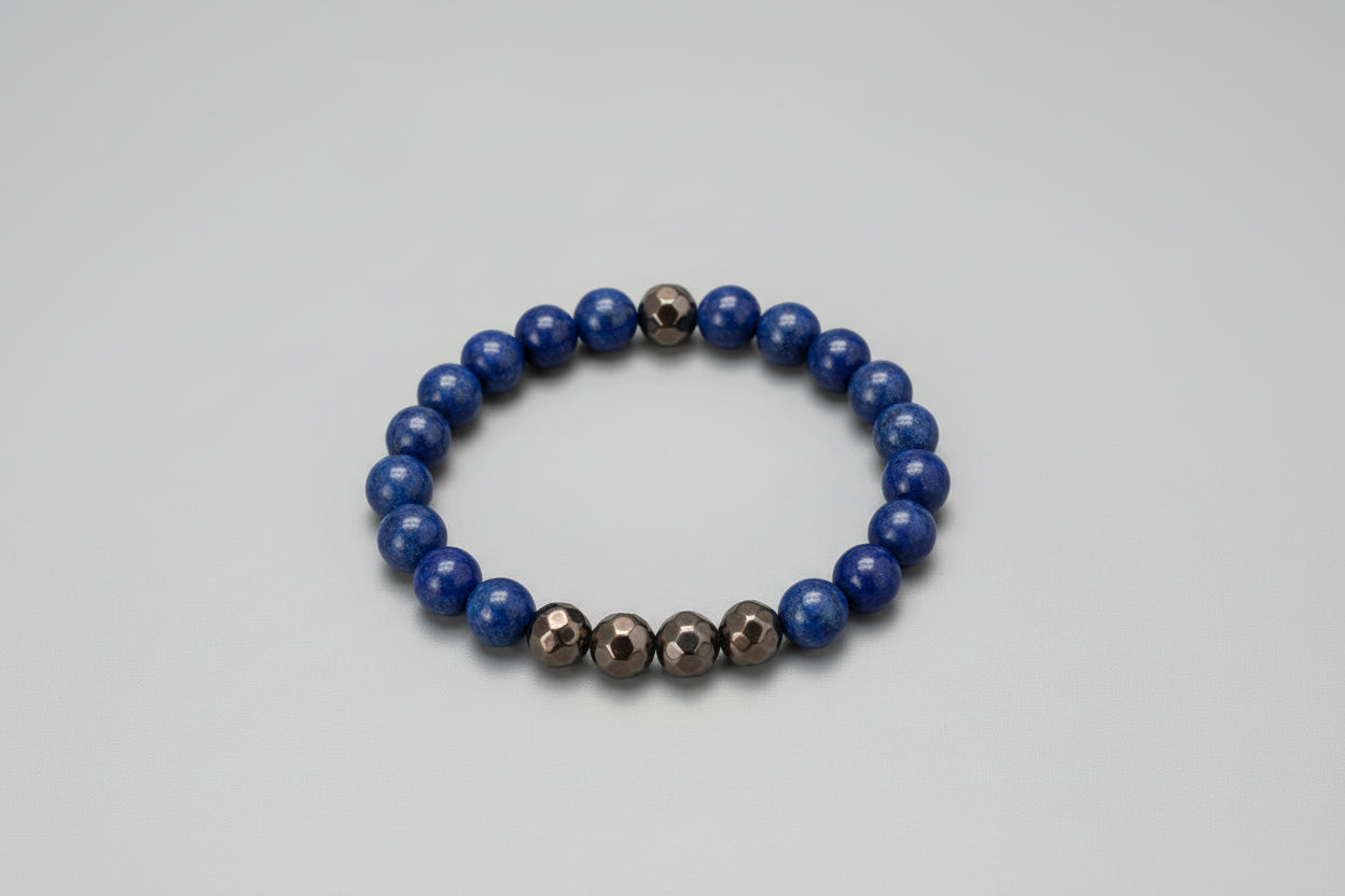 Blue beaded bracelet with brown faceted beads on a black surface