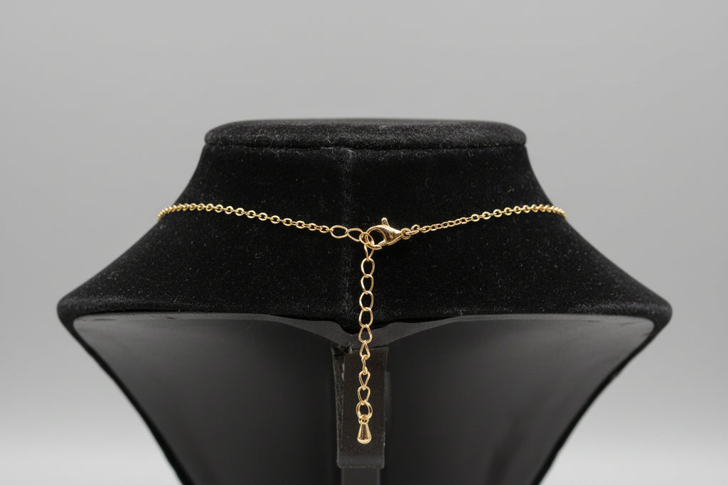 Gold chain necklace on a black velvet stand