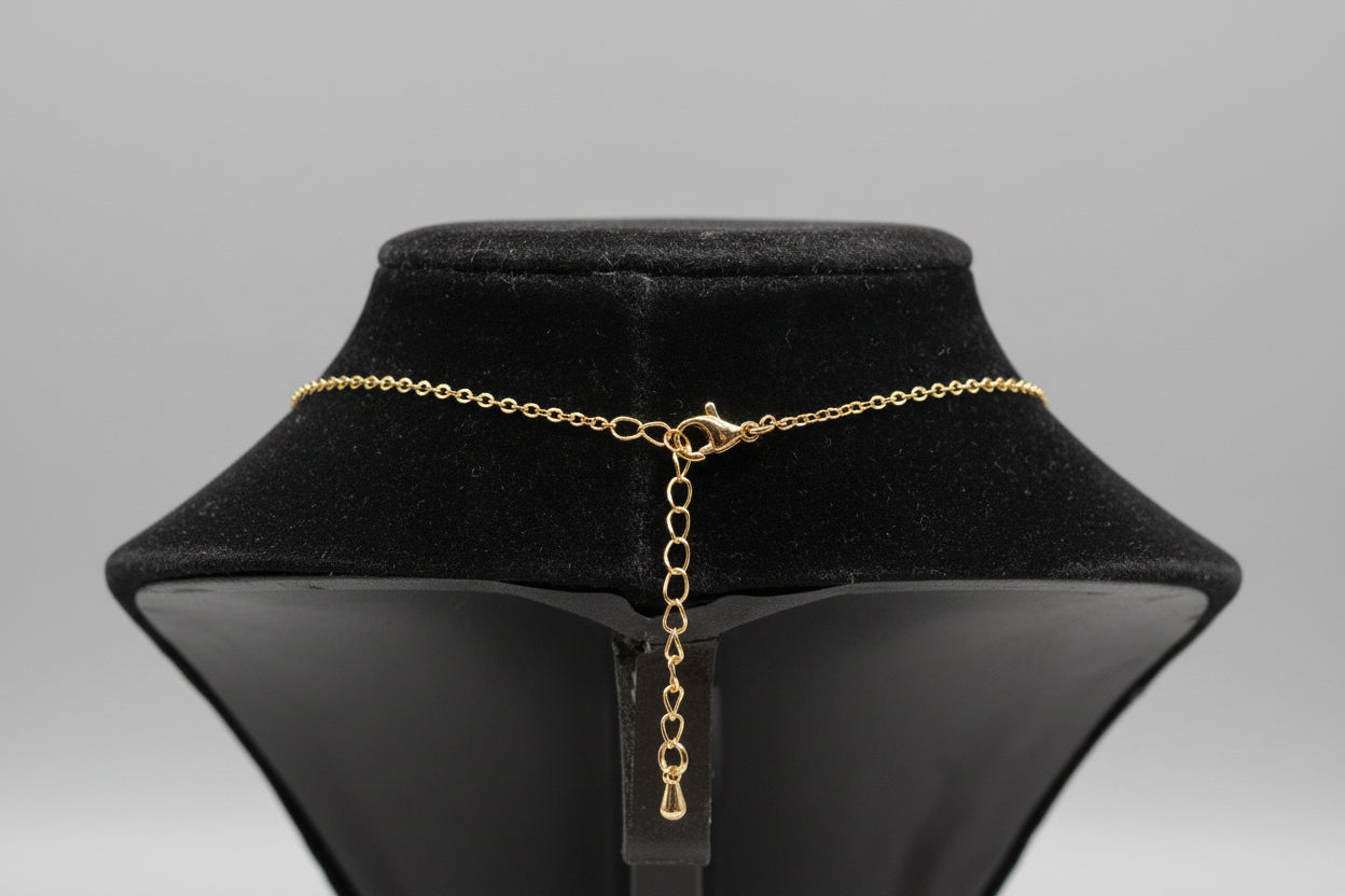 Gold chain necklace on a black velvet stand