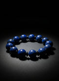 Blue beaded bracelet on a black background
