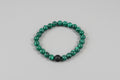Malachite and Matte Lava Bead bracelet on wooden surface