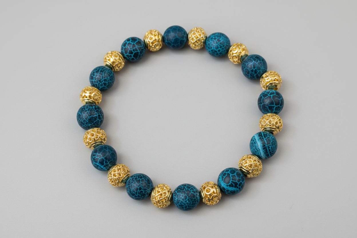 Bracelet with blue and gold beads on a wooden surface