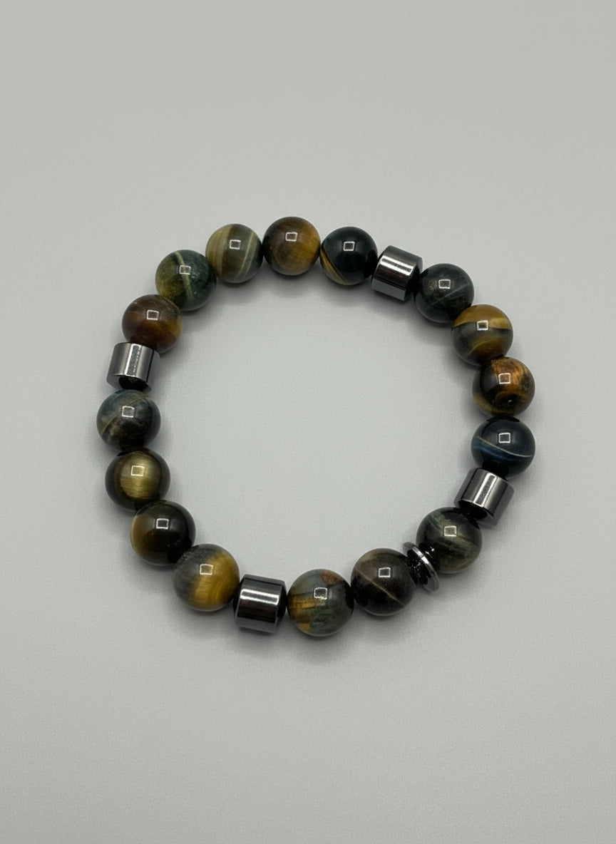 Beaded bracelet with golden brown and black stones on a wooden surface