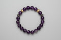Deep Amethyst beaded bracelet on a wooden surface