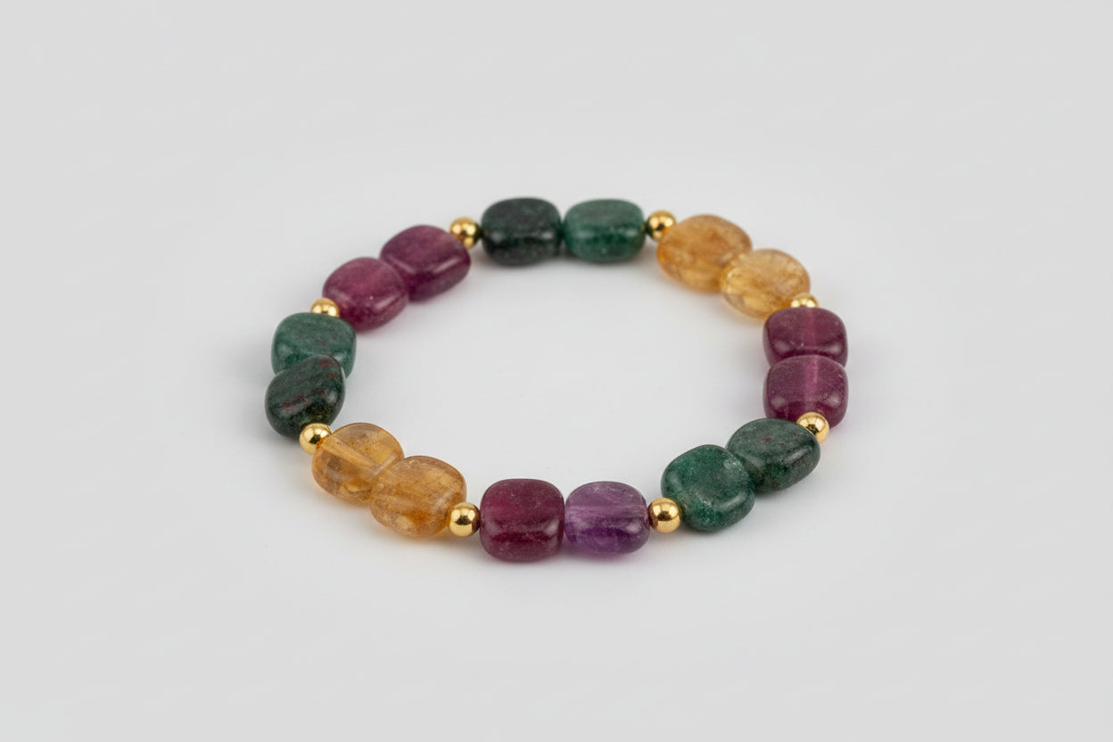 Multicolored gemstone bracelet on a wooden surface