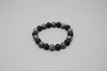 Black beaded bracelet with colorful beads on a wooden surface