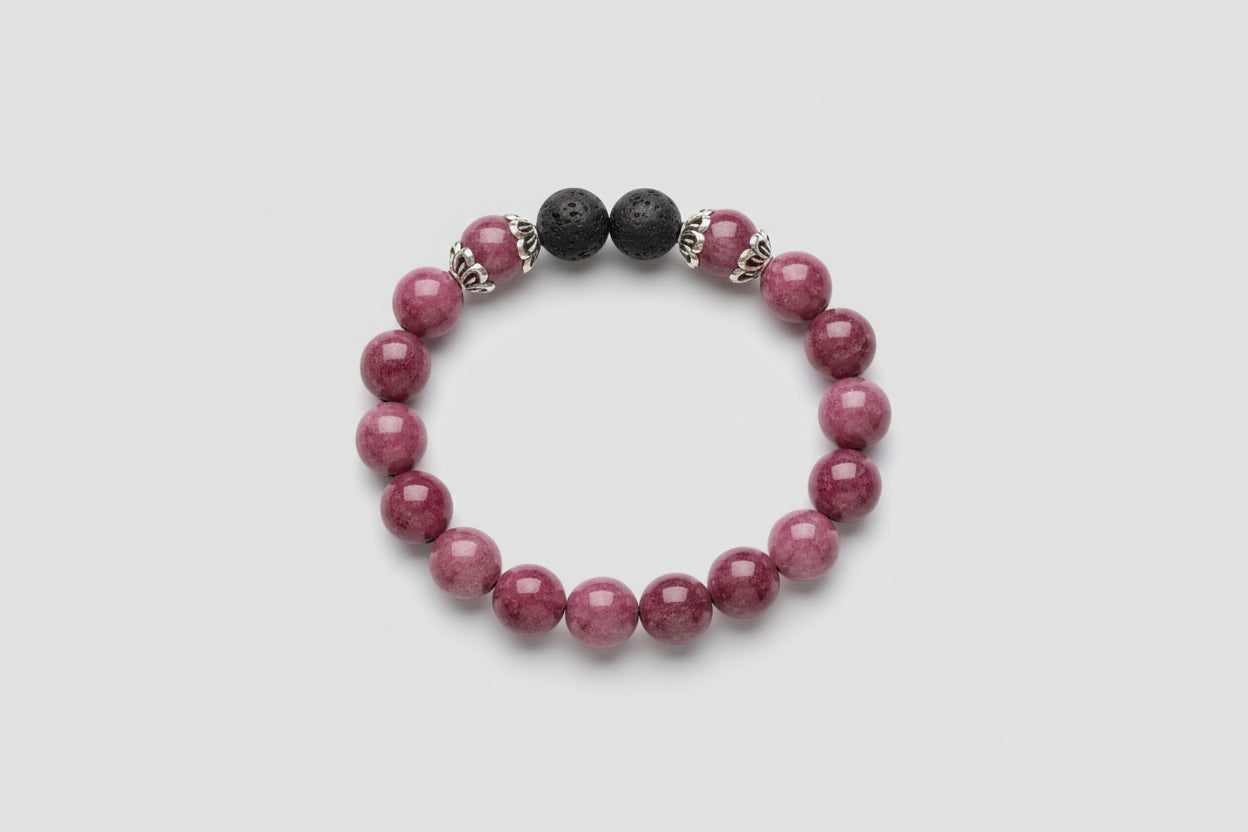 Bracelet with purple and black lava beads on a wooden surface