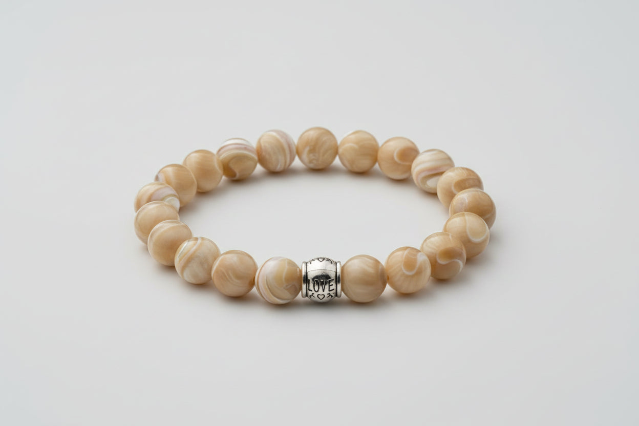 Beaded bracelet with a silver spacer on a wooden surface