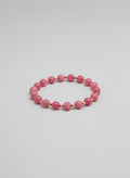 Pink beaded bracelet on a wooden surface
